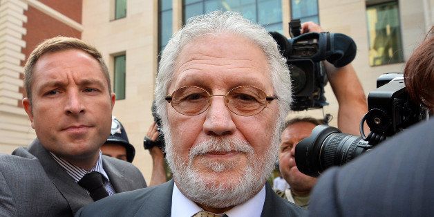 British former radio presenter Dave Lee Travis (C) leaves Westminster Magistrates Court in central London on August 23, 2013 following a hearing for charges of indecent and sexual assault. Travis, who counts Myanmar democracy leader Aung San Suu Kyi among his fans, was arrested on November 15, 2012 as part of a police investigation into allegations of sexual offences against his late colleague Jimmy Savile. The charges of indecent assault relate to eight women aged between 15 and 29. Travis has publically protested his innocence. AFP PHOTO / BEN STANSALL (Photo credit should read BEN STANSALL/AFP/Getty Images)