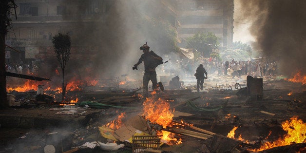 [UNVERIFIED CONTENT] Reporters run for cover during clashes between Muslim Brotherhood supporters of Egypt's ousted president Mohamed Morsi, and police in Cairo on August 14, 2013, as security forces backed by bulldozers moved in on two huge pro-Morsi protest camps, launching a long-threatened crackdown that left dozens dead. Egypt's bloody crackdown on supporters of Morsi triggered widespread condemnation as the international community reacted with alarm to the deepening crisis. The action has resulted in more than 600 deaths, according to official sources.