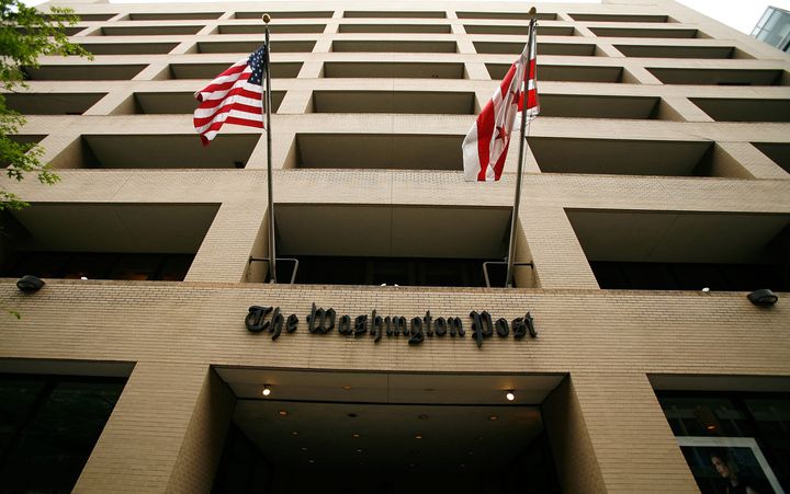 WASHINGTON - MAY 01: Flags wave in front of the Washington Post building on May 1, 2009 in Washington, DC. The newspaper has announced its first quarter earnings with a net loss of $19.5 million. (Photo by Alex Wong/Getty Images)