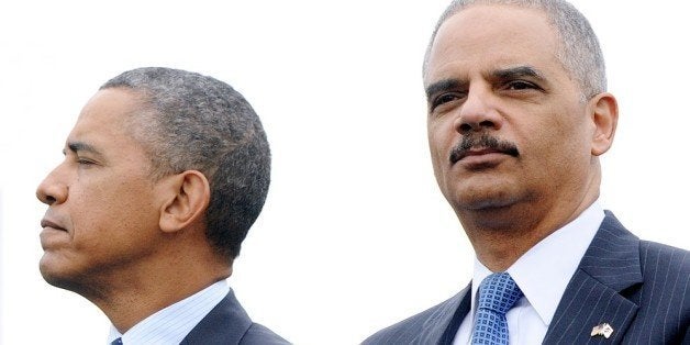 WASHINGTON, DC - MAY 15: (AFP OUT) U.S. President Barack Obama (L) and Attorney General Eric Holder attend the 32nd annual National Peace Officers' Memorial Service at the West Front Lawn at the U.S. Capitol May 15, 2013 in Washington, DC. President Barack Obama delivered remarks at the event, invoking the law enforcement officers who worked to bring the Boston Marathon bombing suspects to justice. (Photo by Olivier Douliery - Pool/Getty Images)