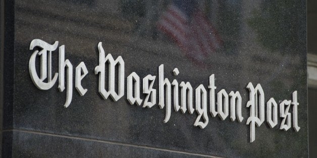 A sign hangs on the outside of the Washington Post Building August 6, 2013 in Washington, DC, the day after it was announced that Amazon.com founder and CEO Jeff Bezos had agreed to purchase the newspaper for USD 250 million. Multi-billionaire Bezos, who created Amazon, which has soared in a few years to a dominant position in online retailing, said he was buying the Post in his personal capacity and hoped to shepherd it through the evolution away from traditional newsprint. AFP PHOTO / Saul LOEB (Photo credit should read SAUL LOEB/AFP/Getty Images)