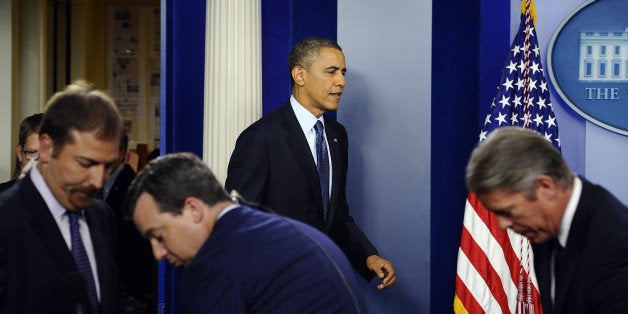 US President Barack Obama (C) arrives to give a press conference in the Brady Press Briefing Room at the White House in Washington, DC, on October 8, 2013, as the crisis over a US government shutdown and debt ceiling standoff deepens. Obama on Tuesday told House Republicans to stop making threats and pass a budget, which would bring an end to a crippling government shutdown. AFP Photo/Jewel Samad (Photo credit should read JEWEL SAMAD/AFP/Getty Images)