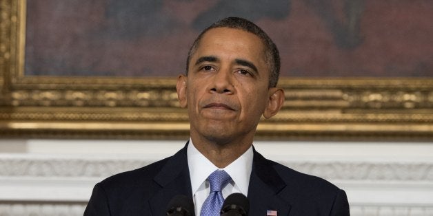US President Barack Obama speaks about the reopening of the US government following a shutdown, in the State Dining Room of t