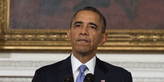 US President Barack Obama speaks about the reopening of the US government following a shutdown, in the State Dining Room of the White House in Washington, DC, on October 17, 2013. Obama warned Thursday that America's political dysfunction had encouraged its enemies and depressed its friends, and said the crisis had left 'no winners' in Washington. Obama called on warring politicians to come together to pass a long term budget and to give up the 'brinksmanship' that threatens the economy and squandered the trust of the American people. AFP PHOTO / Saul LOEB (Photo credit should read SAUL LOEB/AFP/Getty Images)