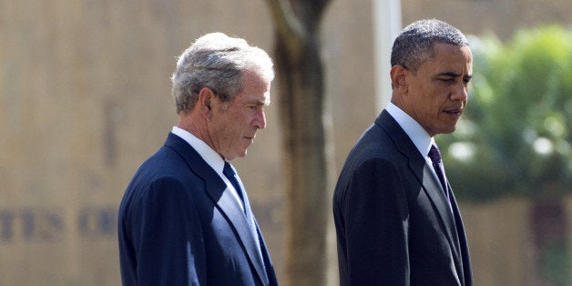 US President Barack Obama (R) and former US President George W. Bush arrive on July 2, 2013 for a wreath-laying ceremony for the victims of the 1998 US Embassy bombing at the Bombing Memorial in Dar Es Salaam. Bush is in Tanzania for a forum of regional First Ladies, hosted by his wife Laura, which will also be attended by First Lady Michelle Obama. AFP PHOTO / Saul LOEB (Photo credit should read SAUL LOEB/AFP/Getty Images)