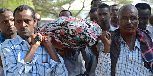 Relatives and fellow journalists carry the body of Somali journalist Mohamed Mohamud Timacade, on October 27, 2013, during his funeral after he succumbed to severe bullet injuries at a hospital in the capital, Mogadishu. Mohamed Mohamud Timacade, a reporter with London-based Somali-language Universal TV, was shot several times in the neck, chest and shoulder earlier in the week after attackers sprayed his car with bullets. Eighteen media professionals were killed in Somalia in 2012 -- the east African country's deadliest year on record, according to Reporters Without Borders (MSF) -- and more than 50 have been killed in the last six years. AFP PHOTO / Mohamed ABDIWAHAB (Photo credit should read Mohamed Abdiwahab/AFP/Getty Images)