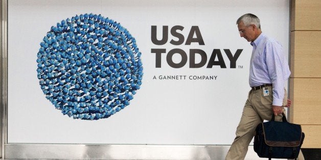 An unidentified man walks through the lobby of the Gannett-USA Today headquarters building August 20, 2013 on a 30-acre site in McLean, Virginia. AFP PHOTO/Paul J. Richards (Photo credit should read PAUL J. RICHARDS/AFP/Getty Images)