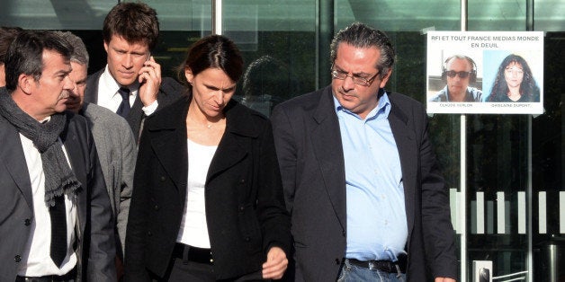 French Minister for Culture and Communication Aurelie Filippetti (C)next to Bruno Daroux (L) assistant to the director of RFI, director of the world department, arrives at French radio station Radio France Internationale (RFI) in Paris on November 3, 2013. French President Francois Hollande opened an ermergency meeting on the shock abduction and killing of two French radio journalists by armed men in northern Mali, whom Fabius said had been shot dead. Radio France Internationale (RFI) reporters Ghislaine Dupont and Claude Verlon were abducted by unknown assailants on November 2, 2013 in the northern Malian city of Kidal. AFP PHOTO / PIERRE ANDRIEU (Photo credit should read PIERRE ANDRIEU/AFP/Getty Images)