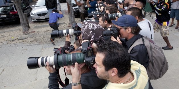 VENICE BEACH, CA - APRIL 16: Paparazzis stalk Lindsay Lohan during a visit with her lawyers on April 16, 2010 in Venice Beach, California. Several of them work for Francois Regis Navarre, who has revolutionized the way paparazzis track celebrities, and who is the owner of X17, one of the world's most successful paparazzi photo agency. Navarre came to the U.S from France in the 90's to be a mainstream newspaper correspondent. He free-lanced for prestigious Le Monde, but became fascinated by Hollywood and decided to become a paparazzi. After several huge scoops, including the first pictures of Michael Jackson's children, he founded X17, today one of the world's largest paparazzi photo agency. With his American wife Brandy, Navarre employs between 60 and 100 photographers and various tipsters (valet car employees, restaurant workers, limo drivers, and even street bums). Today, X17 generates 12 millions dollars a year. Navarre is credited with changing the ways paparazzi stalk their prey: he used video before it became trendy, assigned full time crews to specific neighborhoods or celebrities (15 people full time on Britney Spear, for example), and revolutionized how paparazzis work: 'I asked my paparazzis not to hide anymore, but instead to wait on the sidewalk with wide-angle and a flash', giving birth to the clusters of paparazzis following celebrities in the open. Navarre does not hide either: he lives in a luxury house in Pacific Palissades, an exclusive Los Angeles neighborhood prized by the very Hollywood stars he stalks. (Photo Gilles Mingason/Getty Images)