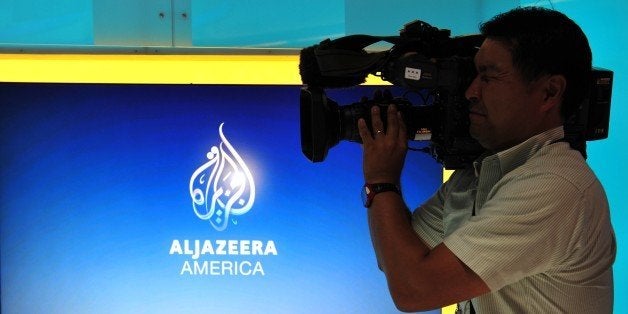 A television cameraman takes video of the new Al Jazeera America television broadcast studio on West 34th Street August 16, 2