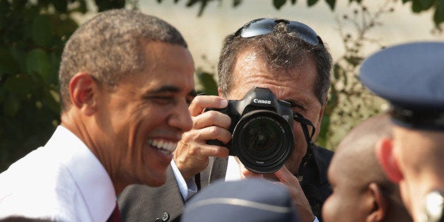 ARLINGTON, VA - SEPTEMBER 11: As White House photographer Pete Souza makes images, U.S. President Barack Obama greets family members of the victims and survivors of the September 11, 2001 attack on the Pentagon during a ceremony in observance of the terrorist attacks at the Pentagon September 11, 2013 in Arlington, Virginia. Family members of the Pentagon attack victims and survivors of the attack gathered to hear from Obama and other leaders at the National 9/11 Pentagon Memorial near the place where terrorists drove a jetliner into the Department of Defense headquarters in 2001. (Photo by Chip Somodevilla/Getty Images)