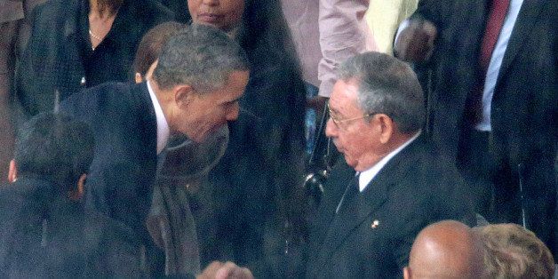 JOHANNESBURG, SOUTH AFRICA - DECEMBER 10: (EDITORS NOTE: Retransmission of #454753083 with alternate crop.) U.S. President Barack Obama (L) shakes hands with Cuban President Raul Castro during the official memorial service for former South African President Nelson Mandela at FNB Stadium December 10, 2013 in Johannesburg, South Africa. Over 60 heads of state have travelled to South Africa to attend a week of events commemorating the life of former South African President Nelson Mandela. Mr Mandela passed away on the evening of December 5, 2013 at his home in Houghton at the age of 95. Mandela became South Africa's first black president in 1994 after spending 27 years in jail for his activism against apartheid in a racially-divided South Africa. (Photo by Chip Somodevilla/Getty Images)
