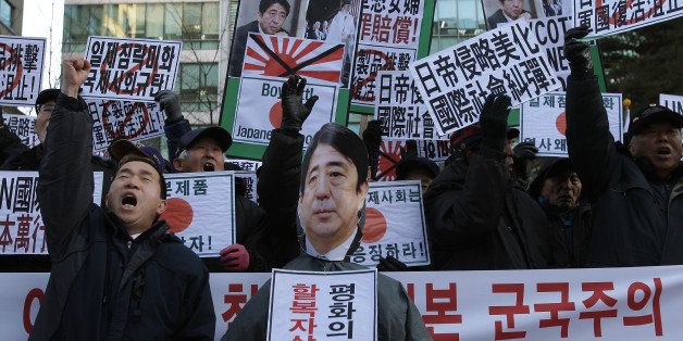 SEOUL, SOUTH KOREA - DECEMBER 27: South Korean conservative protesters shout slogans during a anti-Japan rally in front of the Japanese embassy on December 27, 2013 in Seoul, South Korea. On December 26, 2013, Japanese Prime Minister Shinzo Abe visited the controversial shrine which honors Japan's war dead including war criminals during the period from 1867 to the end of the Second World War. (Photo by Chung Sung-Jun/Getty Images)