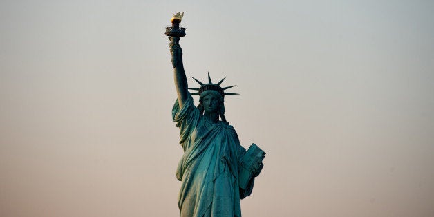 The Statue of Liberty stands in this aerial photograph taken in New York, U.S., on Tuesday, Dec. 3, 2013. U.S. stocks decline