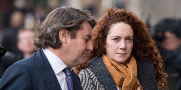 Rebekah Brooks (R), former News International chief executive, and her husband Charlie (L) arrive for the phone-hacking trial at the Old Bailey court in London on December 9, 2013. Eight defendants are on trial in the case, including former News of the World editors Rebekah Brooks and Andy Coulson. They all deny the charges, which arise from the scandal that shut the News of the World in July 2011. AFP PHOTO / LEON NEAL (Photo credit should read LEON NEAL/AFP/Getty Images)