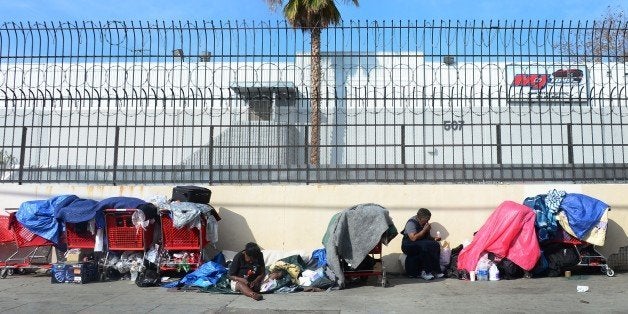 Homeless women sit amid their belongings on a street in downtown Los Angeles, California, on January 8, 2014. Poverty in the world's largest economy remains far from being eradicated fifty years after President Lyndon Johnson declared a war on poverty in America in his first State of the Union address on this date in 1964, with a US Census Bureau report revealing on January 7 that nearly one in three Americans experienced poverty for at least two months during the global recession between 2009 and 2011. And in 2012, poverty affected some 47 million Americans, including 13 million children. AFP PHOTO/Frederic J. BROWN (Photo credit should read FREDERIC J. BROWN/AFP/Getty Images)