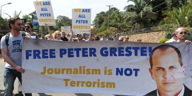 Foreign journalists hold banners bearing a picture of Peter Greste, an Australian journalist who was arrested and detained in Cairo while on assignment for Qatar-based Al-Jazeera network, on December 29, 2013, as they march to the Egyptian Embassy in Nairobi, on February 4, 2014. Greste and two others journalists are accused of spreading lies harmful to state security and joining a terrorist organisation.AFP PHOTO/SIMON MAINA (Photo credit should read SIMON MAINA/AFP/Getty Images)