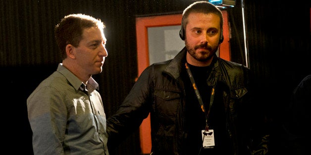 American journalist Jeremy Scahill, right, and Glenn Greenwald wait for the beginning of a panel following the screening of the "Dirty Wars" documentary at the Rio Film Festival in Rio de Janeiro, Brazil, Saturday, Sept. 28, 2013. Greenwald, who has thousands of leaked National Security Archive documents, participated in a panel with Scahill following the screening of the documentary "Dirty Wars" based on his book by the same name about covert operations. (AP Photo/Silvia Izquierdo)