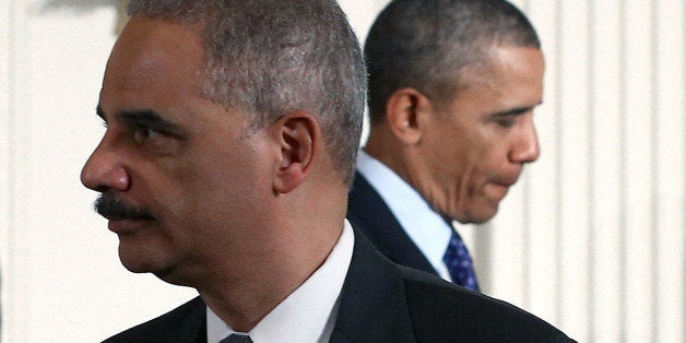 WASHINGTON, DC - JANUARY 22: U.S. President Barack Obama (R) walks past US Attorney General Eric Holder (L) during an event in the East Room of the White House, on January 22, 2014 in Washington, DC. President Obama signed a memorandoum for the Heads of Executive Departments and Agencies regarding establishing a White House Task Force to Protect Students from Sexual Assault during an event for the Council on Women and Girls. (Photo by Mark Wilson/Getty Images)