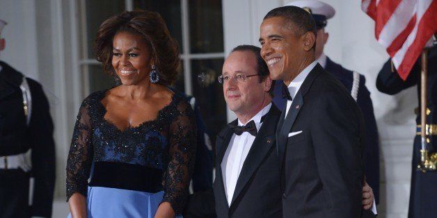 US President Barack Obama and First Lady Michelle Obama pose with French President Francois Hollande as he arrives for the State Dinner at the North Portico of the White House on February 11, 2014 in Washington, DC. AFP PHOTO/Mandel NGAN (Photo credit should read MANDEL NGAN/AFP/Getty Images)