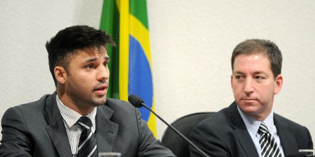 David Miranda (L), partner of the Guardian's Brazil-based reporter Glenn Greenwald (R), who was among the first to reveal Washington's vast electronic surveillance program, speaks before the investigative committee of the Senate that examines charges of espionage by the United States in Brasilia on October 9, 2013, following press reports of US electronic surveillance in Brazil based on leaks from Edward Snowden, a former US National Security Agency contractor. AFP PHOTO/Evaristo Sa (Photo credit should read EVARISTO SA/AFP/Getty Images)