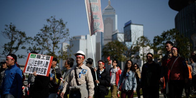 Protesters display placards as they march for press freedom in Hong Kong on February 23, 2014. Thousands took to Hong Kong streets on February 23 to march for press freedom, in a protest organised by journalists as fears grow that free expression is being compromised. AFP PHOTO / Philippe Lopez (Photo credit should read PHILIPPE LOPEZ/AFP/Getty Images)