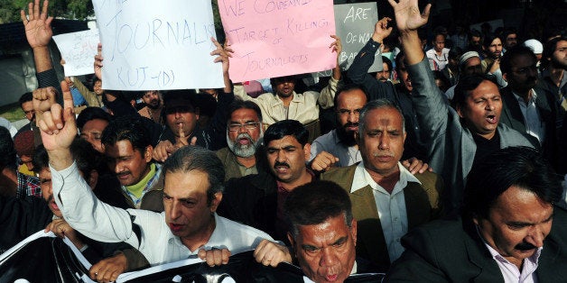 Pakistani journalists shout slogans against the killing of Wali Khan Babar, a reporter with a local television channel Geo News, during a rally in Karachi on January 14, 2011. Babar, an ethnic Pashtun from southwestern Balochistan province, was believed to be yet another victim of ongoing ethnic targeted killings on January 13 in Pakistan's financial hub of Karachi. AFP PHOTO/ ASIF HASSAN (Photo credit should read ASIF HASSAN/AFP/Getty Images)