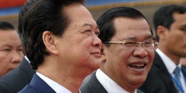 Vietnamese Prime Minister Nguyen Tan Dung (L) walks with Cambodian Prime Minister Hun Sen (R) during the official inauguration ceremony of Cho Ray-Phnom Penh hospital in Phnom Penh on January 13, 2014. Nguyen Tan Dung began a three-day working visit to Cambodia aimed at boosting bilateral ties. AFP PHOTO / TANG CHHIN SOTHY (Photo credit should read TANG CHHIN SOTHY/AFP/Getty Images)