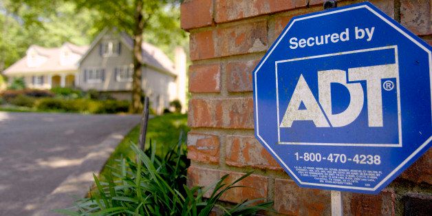 UNITED STATES - MAY 11: An ADT Security sign sits out in front of a home in Sandy Springs, Georgia Friday, May 11, 2007. Tyco bondholder American International Group Inc. this week sued the owner of ADT security systems in an effort to block it from buying back $6.6 billion of debt as part of a plan to split into three companies. (Photo by Chris Rank/Bloomberg via Getty Images)