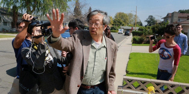 Dorian S. Nakamoto, identified by Newsweek magazine as the founder of Bitcoin, exits his home surrounded by members of the me