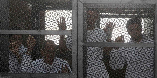 CAIRO, EGYPT - MARCH 5: Trial of Al Jazeera staff, including 4 foreigners and 16 Egyptians, is heard at Police Institution in Cairo, Egypt on March 5, 2014. Journalists are accused of spreading false news and belonging to 'terrorist group', and broadcasting against Egypt. Peter Greste is seen (2ndL) during the trial. (Photo by Tarek Wajeh/Anadolu Agency/Getty Images)