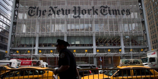An New York City Police Department (NYPD) police officer passes in front of The New York Times Co. offices in New York, U.S.,