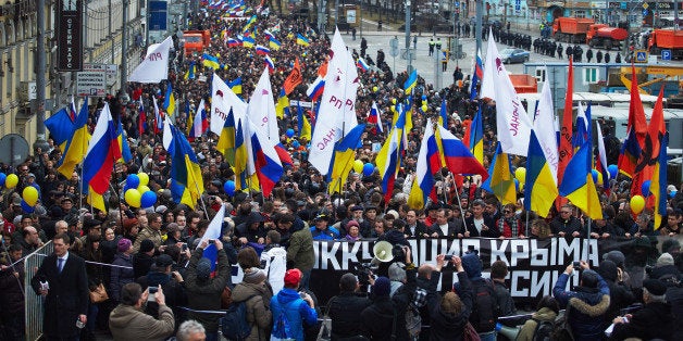 MOSCOW. RUSSIA - MARCH 15: Anti-Putin demonstrators carrying Russian and Ukrainian flags march to oppose president Vladimir Putin's policies in Ukraine and a possible war in Crimea, on March 15, 2014 in Moscow, Russia. Thousands of Muscovites gathered for the rally in Central Moscow as Crimeans vote tomorrow on whether to secede and join Russia. (Photo by Oleg Nikishin/Getty Images)