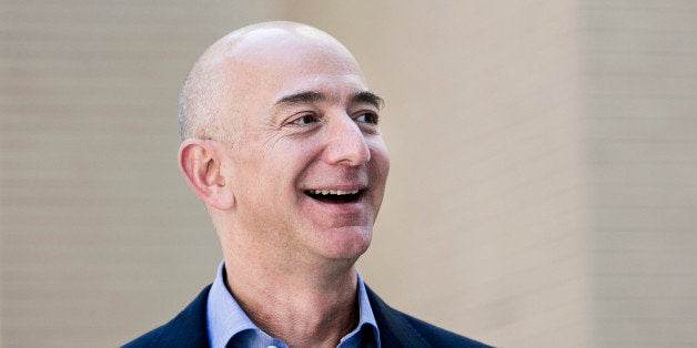 Jeff Bezos, founder and chief executive officer of Amazon Inc. and new owner of The Washington Post, leaves from the newspaper's offices after a meeting in Washington, D.C., U.S., on Wednesday, Sept. 4, 2013. Bezos agreed last month to buy the Washington Post for $250 million in a bet that he can apply his success in e-commerce to the struggling newspaper industry. Photographer: T.J. Kirkpatrick/Bloomberg via Getty Images