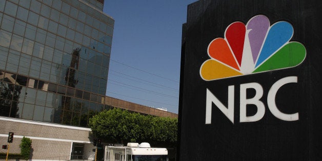 BURBANK, CA - OCTOBER 20: The NBC peacock logo hangs on the NBC studios building as a mobile home is parked nearby on Octobe