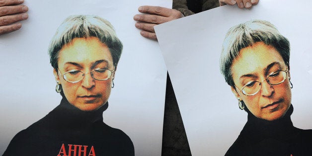 Russian human rights activists attend a rally in honour of slain Russian journalist Anna Politkovskaya in Moscow on October 7, 2010. The Russian investigative journalist, known for her critical coverage of the war in Chechnya, was found murdered 07 October 2006 in the hallway of the building where she lived in Moscow. AFP PHOTO / NATALIA KOLESNIKOVA (Photo credit should read NATALIA KOLESNIKOVA/AFP/Getty Images)