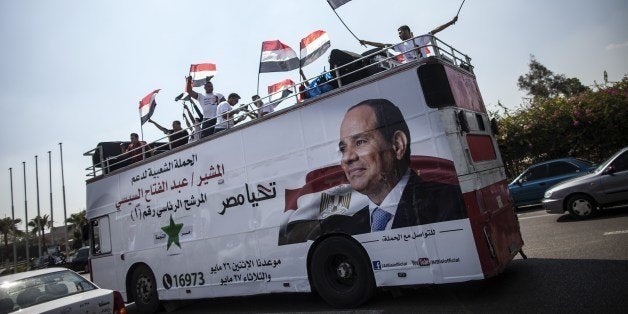 Supporters of Egyptian ex-army chief and leading presidential candidate Abdel Fattah al-Sisi wave national flags from the top