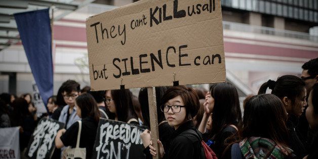 Protesters display placards during a rally to support press freedom in Hong Kong on March 2, 2014. The rally was staged following the attack of a former editor of local liberal newspaper which comes at a time of growing unease over freedom of the press in the southern Chinese city, with mounting concerns that Beijing is seeking to tighten control over the semi-autonomous region. AFP PHOTO / Philippe Lopez (Photo credit should read PHILIPPE LOPEZ/AFP/Getty Images)
