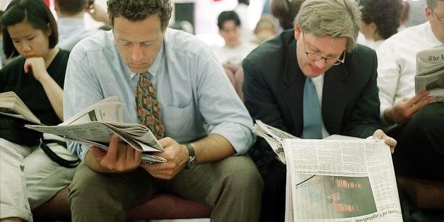 WASHINGTON, DC - SEPTEMBER 12: Two unidentified men read newspapers while waiting to donate blood 12 September, 2001, at the American Red Cross headquarters in Washington, DC. The terrorist attacks 11 September in New York City and Washington have boosted the need for blood supplies. (Photo credit should read CHRIS MADDALONI/AFP/Getty Images)