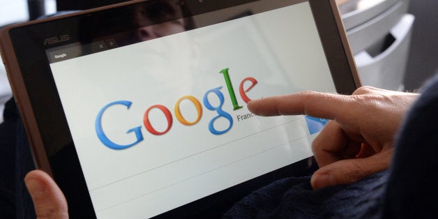 This picture taken on May 13, 2013 in the French western city of Rennes shows a woman choosing Google Search (or Google Web Search) web search engine front page on her tablet. A report by a French expert panel published on May 13, 2013 recommended imposing taxes on smartphones and tablets but rejected a call for search engine Google to be charged for linking to media content. The nine-member panel, headed by respected journalist and businessman Pierre Lescure, said in the keenly awaited report that the revenue gained from the proposed new taxes could help fund artistic and creative ventures. AFP PHOTO / DAMIEN MEYER (Photo credit should read DAMIEN MEYER/AFP/Getty Images)