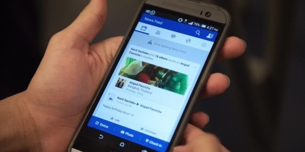 A man check his facebook on his smart phone with a message reading 'error loading news feed' on the skytrain (bts) in Bangkok