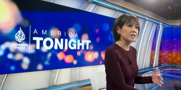 Joie Chen, host of the new Al Jazeera America nightly news program America Tonight, sits at the anchor desk in the network's studio space at the Newseum in Washington, DC, August 16, 2013. Al Jazeera America, a cable news network set to launch on August 20, will have 12 bureaus in major cities in the US, three broadcast centers, a headquarters in New York City, and around 900 journalists and staff. AFP PHOTO / Saul LOEB (Photo credit should read SAUL LOEB/AFP/Getty Images)