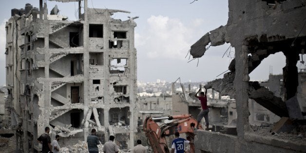 Palestinian men inspect the destruction in part of Gaza City's al-Tufah neighbourhood as the fragile ceasefire in the Gaza St