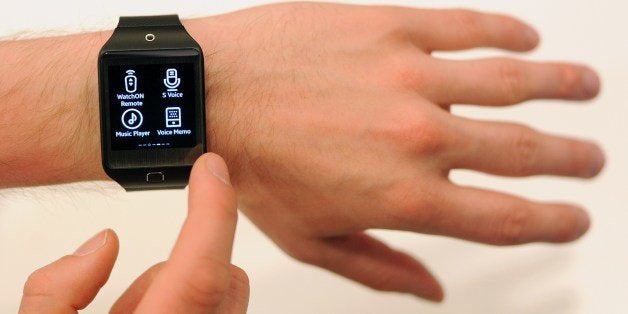 A Samsung employee demonstrates the new SM-R381 Smartwatch at the Tizen Developer Conference in San Francisco, California on June 3, 2014. AFP PHOTO/JOSH EDELSON (Photo credit should read Josh Edelson/AFP/Getty Images)