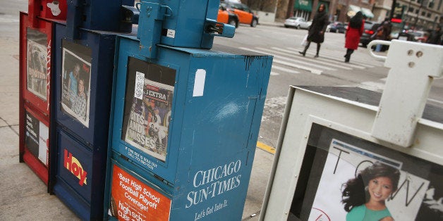 CHICAGO, IL - DECEMBER 02: A vending machine sells Chicago Sun-Times newspapers on a street corner in the Loop on December 2, 2013 in Chicago, Illinois. Guild member are expected to vote today on an agreement reached between Wrapports, publisher of the Chicago Sun-Times and other Chicago-area newspapers, and the Chicago Newspaper Guild for a new three-year contract. Reports suggest the new contract could lead to the company rehiring 4 of the 28 people who were laid-off last spring when the company eliminated the photography staffs at all of the newspapers, opting to rely on freelance photographers, reporters, and other sources for the images used in the publications. (Photo by Scott Olson/Getty Images)