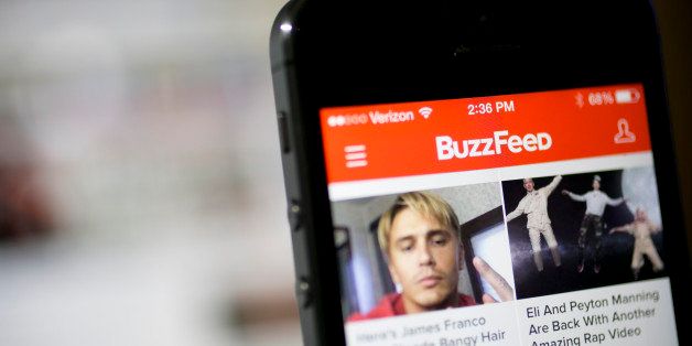 The Buzzfeed Inc. application (app) is displayed on an Apple Inc. iPhone 5s in this arranged photograph in Washington, D.C., U.S., on Monday, Aug. 11, 2014. BuzzFeed Inc. raised $50 million on a bet its mix of everything from animal lists to serious news is more valuable than the coverage produced by established media like the Washington Post and Los Angeles Times. Photographer: Andrew Harrer/Bloomberg via Getty Images