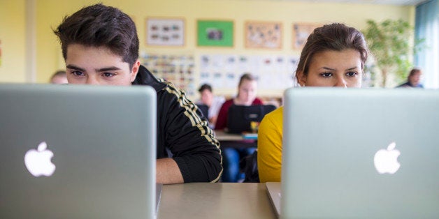 BERLIN, GERMANY - OCTOBER 25: Pupils working at their lap-tops in a lesson at the Heinrich-Mann-School in the Neukoelln distr