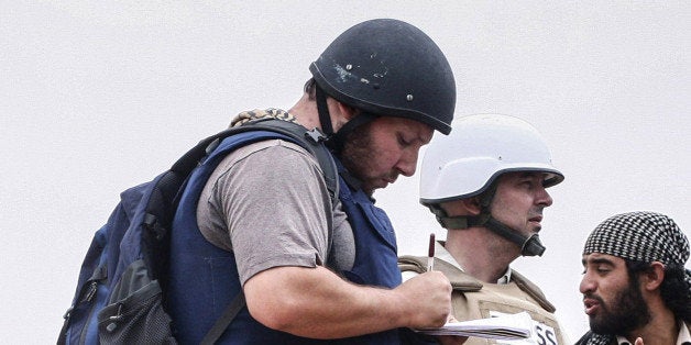 MISRATA, LIBYA - JUNE 02: In this handout image made available by the photographer American journalist Steven Sotloff (Center with black helmet) talks to Libyan rebels on the Al Dafniya front line, 25 km west of Misrata on June 02, 2011 in Misrata, Libya. Sotloff was kidnapped in August 2013 near Aleppo, Syria and was recently shown on a jihadist video in which fellow US journalist James Foley was executed. In the video the militant form the Islamic State (IS) threatens to kill Sotloff next if the US continues its aerial campaign against the insurgency. (Photo by Etienne de Malglaive via Getty Images)