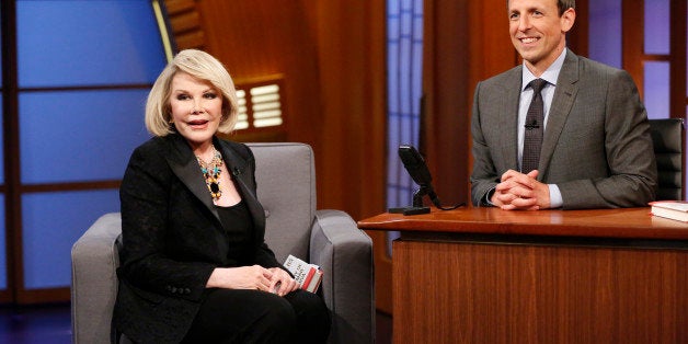 LATE NIGHT WITH SETH MEYERS -- Episode 081 -- Pictured: (l-r) Comeidan Joan Rivers during an interview with host Seth Meyers
