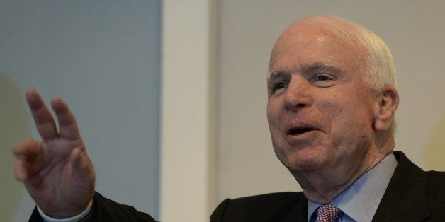 US senator John McCain takes questions during a press conference held jointly with US senator Sheldon Whitehouse (not pictured) in Hanoi on August 8, 2014. The senators held talks with Vietnams top leaders on bilateral, regional security and human rights issues. AFP PHOTO/HOANG DINH Nam (Photo credit should read HOANG DINH NAM/AFP/Getty Images)